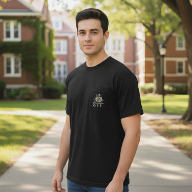 Front view of the Sigma Tau Gamma Sig Tau Midnight Rider Tee on a male model, showing a black Comfort Colors pocket tee with a white rose emblem inspired by Sig Tau tradition