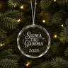 Limited Edition glass Christmas ornament with engraved design hanging on a decorated holiday tree